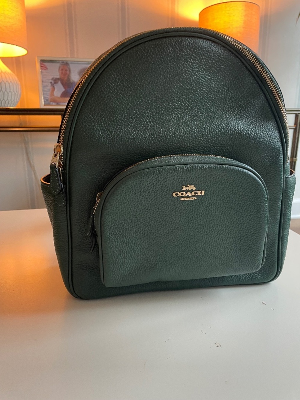 Coach Court Backpack in a rich dark green shade.